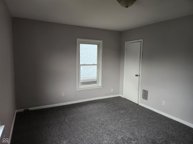 323-325 N Gladstone Ave, Indianapolis, IN 46201 - unfurnished room featuring baseboards and dark colored carpet