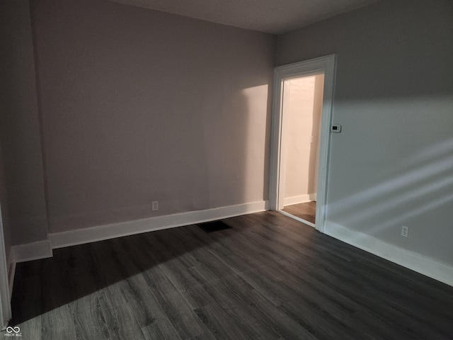 323-325 N Gladstone Ave, Indianapolis, IN 46201 - spare room featuring dark wood-type flooring and baseboards