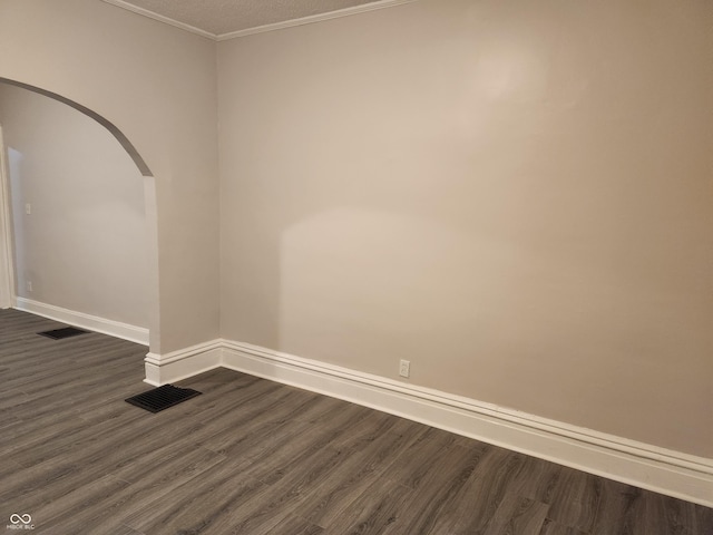 323-325 N Gladstone Ave, Indianapolis, IN 46201 - empty room with arched walkways, dark wood-style flooring, baseboards, and crown molding
