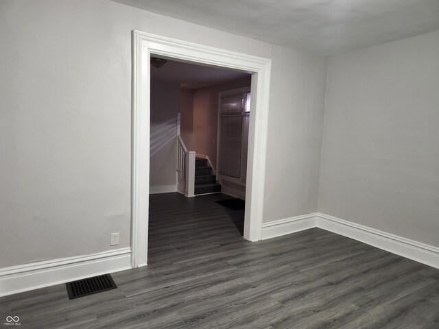 323-325 N Gladstone Ave, Indianapolis, IN 46201 - spare room featuring dark wood-style flooring, baseboards, and stairs