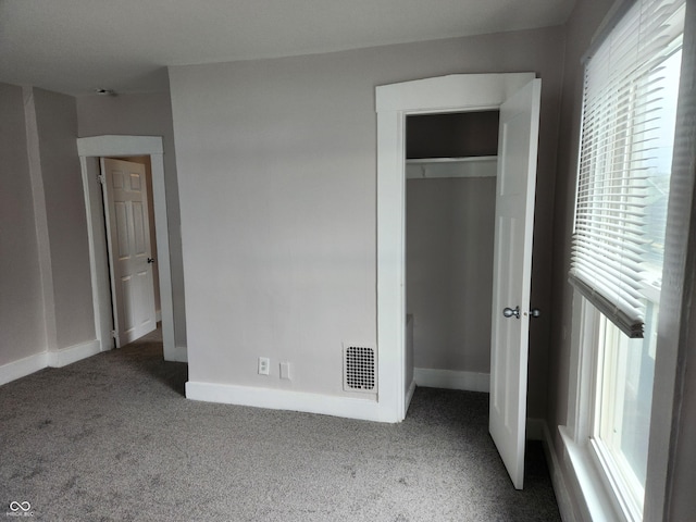 323-325 N Gladstone Ave, Indianapolis, IN 46201 - unfurnished bedroom featuring carpet floors, a closet, and baseboards