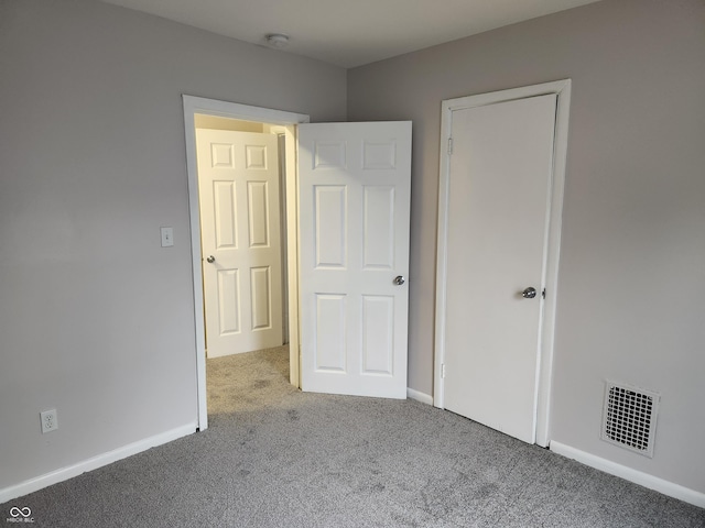 323-325 N Gladstone Ave, Indianapolis, IN 46201 - unfurnished bedroom featuring carpet floors and baseboards