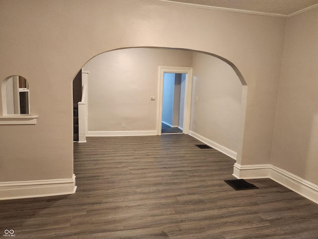323-325 N Gladstone Ave, Indianapolis, IN 46201 - empty room with arched walkways, wood finished floors, baseboards, and ornamental molding