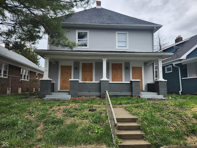 323-325 N Gladstone Ave, Indianapolis, IN 46201 - american foursquare style home with a porch, roof with shingles, and a chimney
