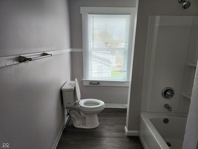 323-325 N Gladstone Ave, Indianapolis, IN 46201 - bathroom with baseboards, toilet, wood finished floors, and tub / shower combination