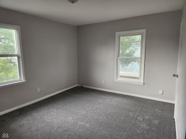 323-325 N Gladstone Ave, Indianapolis, IN 46201 - spare room with plenty of natural light, dark carpet, and baseboards