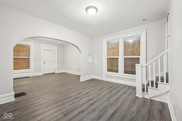 323-325 N Gladstone Ave, Indianapolis, IN 46201 - unfurnished room featuring arched walkways, wood finished floors, and baseboards