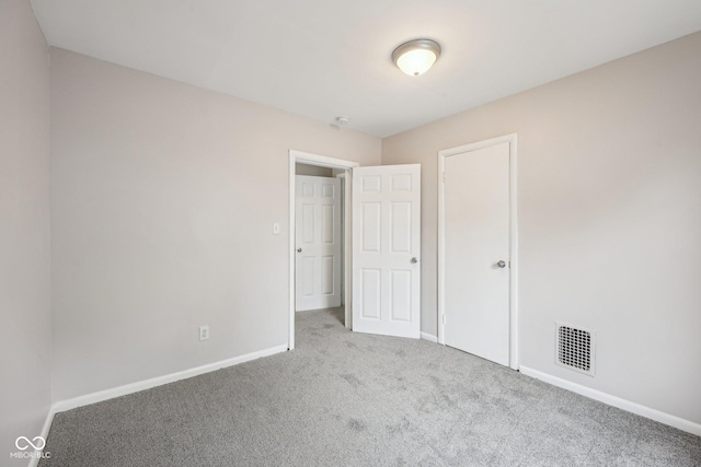 323-325 N Gladstone Ave, Indianapolis, IN 46201 - unfurnished bedroom featuring carpet floors and baseboards
