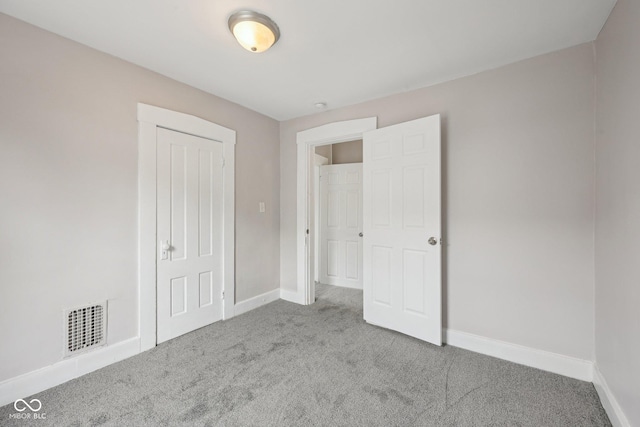 323-325 N Gladstone Ave, Indianapolis, IN 46201 - unfurnished bedroom featuring carpet, baseboards, and a closet