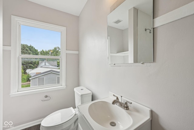 323-325 N Gladstone Ave, Indianapolis, IN 46201 - half bathroom featuring plenty of natural light, vanity, and toilet