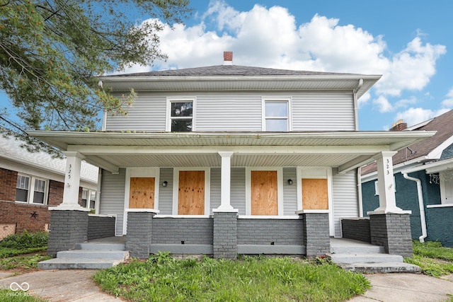 323-325 N Gladstone Ave, Indianapolis, IN 46201 - traditional style home featuring a porch and a chimney