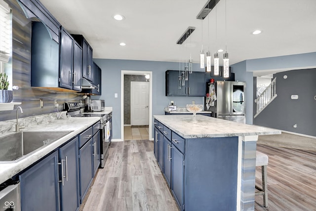 9001 Harrison Run Ct, Indianapolis, IN 46256 - kitchen with appliances with stainless steel finishes, a sink, a kitchen breakfast bar, a kitchen island, and baseboards