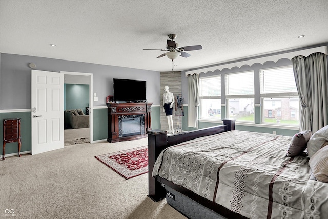 9001 Harrison Run Ct, Indianapolis, IN 46256 - bedroom featuring carpet floors, a textured ceiling, ceiling fan, a glass covered fireplace, and baseboards