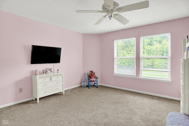 9001 Harrison Run Ct, Indianapolis, IN 46256 - rec room with carpet floors, a ceiling fan, a textured ceiling, and baseboards