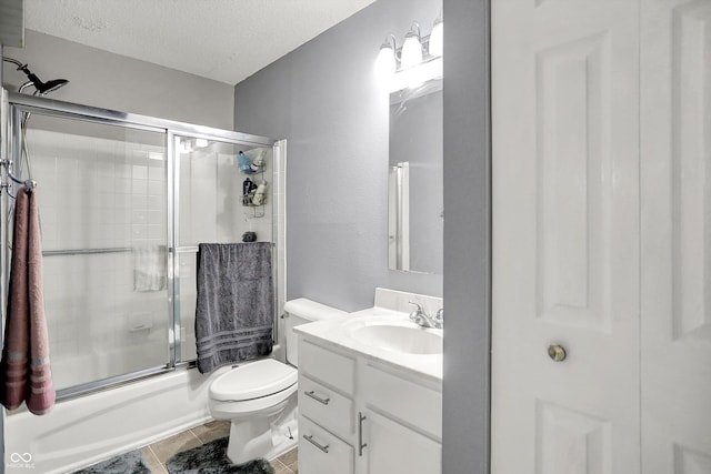 9001 Harrison Run Ct, Indianapolis, IN 46256 - bathroom featuring vanity, a textured ceiling, combined bath / shower with glass door, toilet, and tile patterned flooring