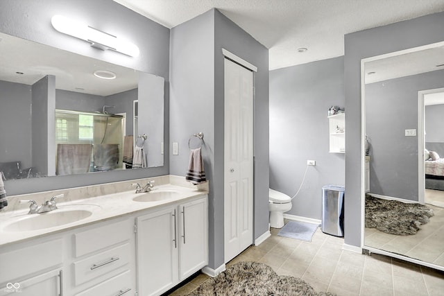 9001 Harrison Run Ct, Indianapolis, IN 46256 - bathroom with double vanity, connected bathroom, a shower, toilet, and tile patterned flooring