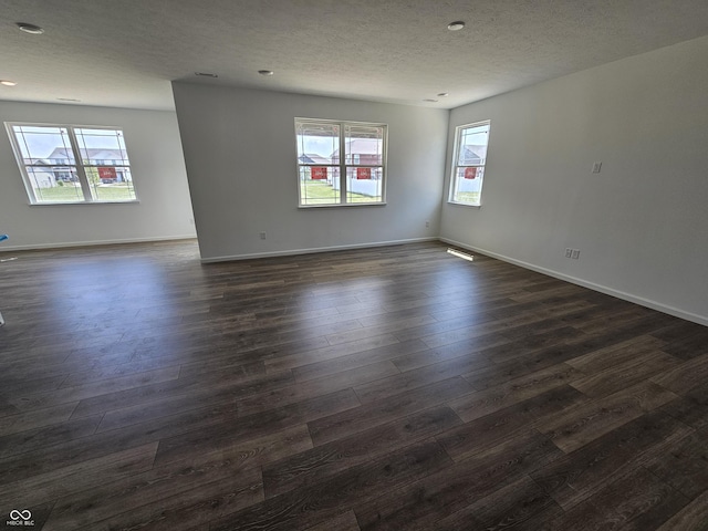 2339 Pine Valley Dr, Plainfield, IN 46168 - spare room with plenty of natural light, a textured ceiling, dark wood finished floors, and recessed lighting