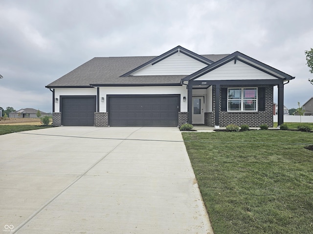 2339 Pine Valley Dr, Plainfield, IN 46168 - view of front facade with a garage, brick siding, a front yard, and concrete driveway