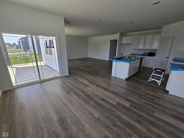 2339 Pine Valley Dr, Plainfield, IN 46168 - kitchen with open floor plan, dark countertops, dark wood-type flooring, white cabinetry, and an island with sink