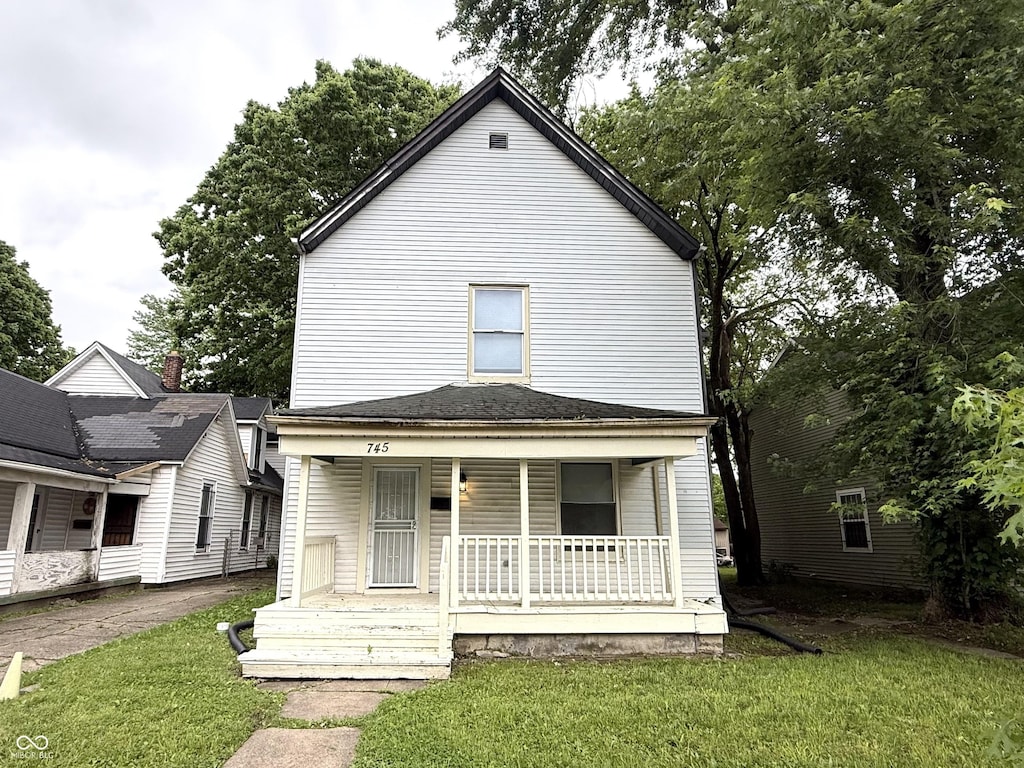 745 N Tremont St, Indianapolis, IN 46222 - view of front of home with a porch and a front yard