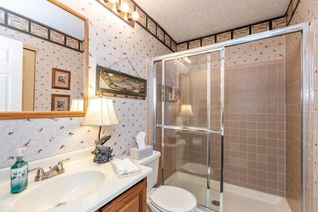 3403 Island Way, Indianapolis, IN 46214 - full bath with wallpapered walls, vanity, toilet, a stall shower, and a textured ceiling