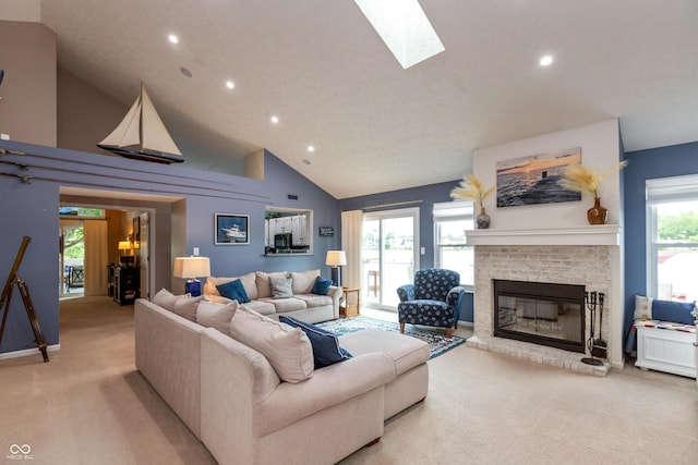 3403 Island Way, Indianapolis, IN 46214 - living area featuring light carpet, high vaulted ceiling, a fireplace, recessed lighting, and a skylight