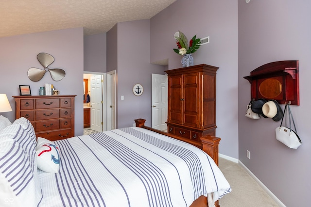 3403 Island Way, Indianapolis, IN 46214 - carpeted bedroom with high vaulted ceiling, baseboards, ensuite bath, and a textured ceiling