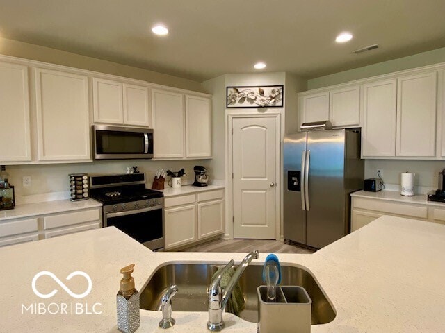 1349 Sunset Blvd, Avon, IN 46123 - kitchen featuring stainless steel appliances, white cabinets, light countertops, and recessed lighting