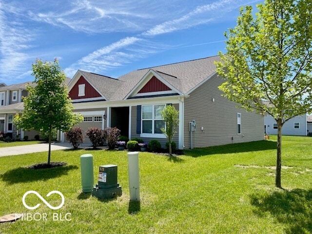 1349 Sunset Blvd, Avon, IN 46123 - view of front of property with a front yard, concrete driveway, an attached garage, and board and batten siding