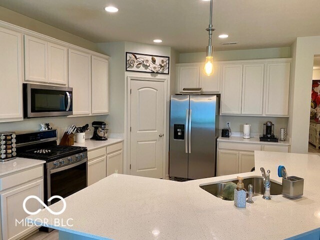 1349 Sunset Blvd, Avon, IN 46123 - kitchen with stainless steel appliances, white cabinets, recessed lighting, pendant lighting, and a sink