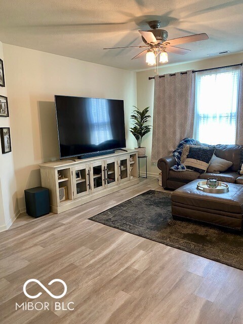 1349 Sunset Blvd, Avon, IN 46123 - living area with ceiling fan, wood finished floors, and baseboards