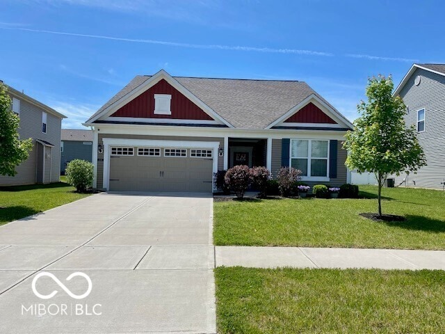 1349 Sunset Blvd, Avon, IN 46123 - craftsman house with a front yard, driveway, board and batten siding, an attached garage, and roof with shingles