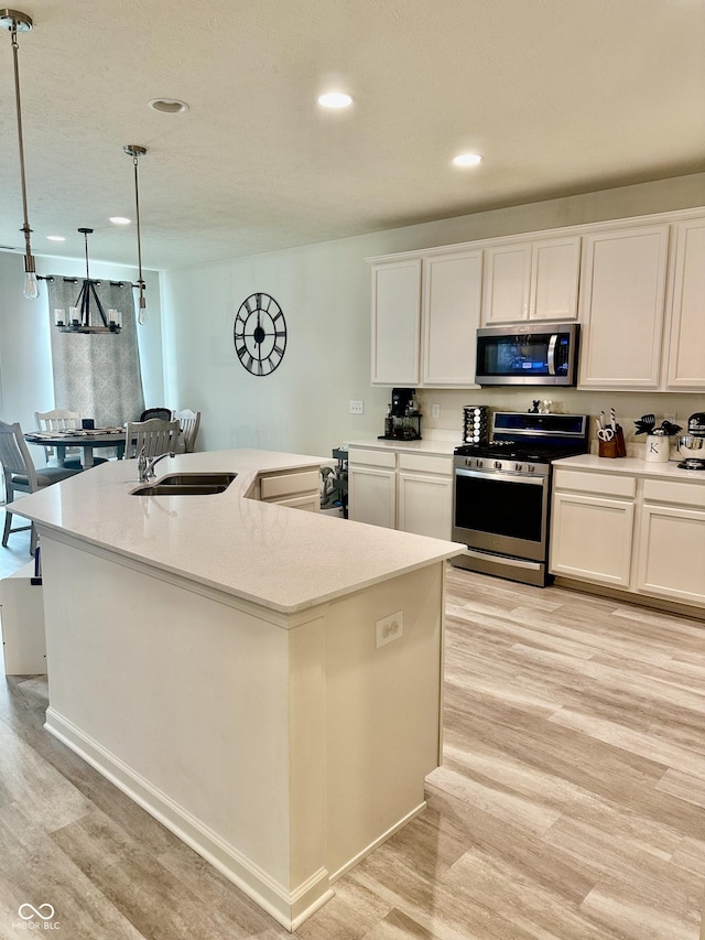 1349 Sunset Blvd, Avon, IN 46123 - kitchen with stainless steel appliances, light wood finished floors, recessed lighting, an island with sink, and white cabinetry