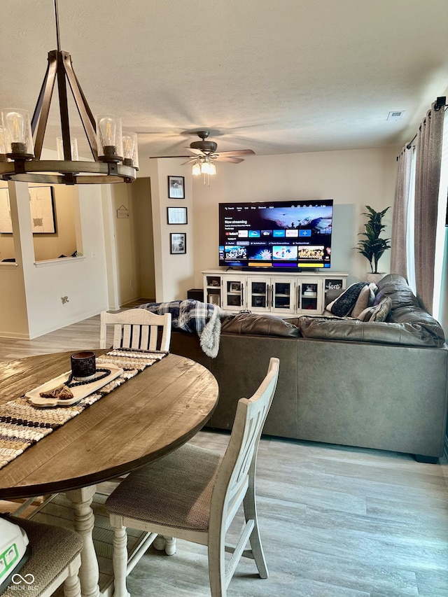 1349 Sunset Blvd, Avon, IN 46123 - dining room with wood finished floors, ceiling fan, and a chandelier