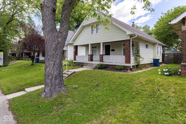 1311 N Oakland Ave, Indianapolis, IN 46201 - view of front facade featuring covered porch and a chimney