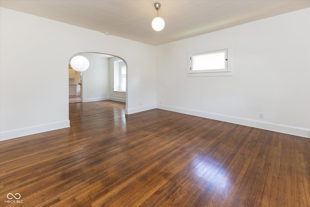 1311 N Oakland Ave, Indianapolis, IN 46201 - spare room with arched walkways, baseboards, and wood finished floors