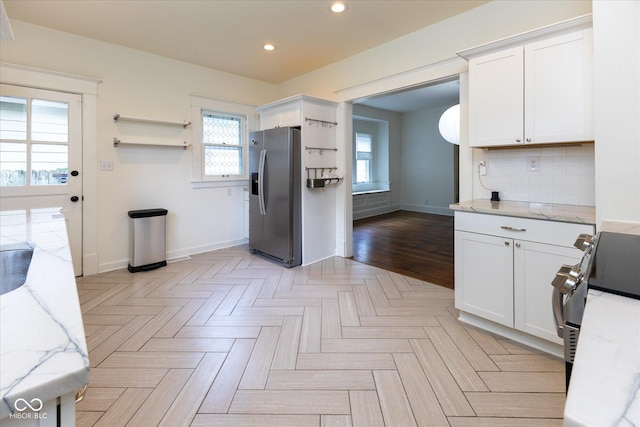 1311 N Oakland Ave, Indianapolis, IN 46201 - kitchen with stainless steel fridge, baseboards, recessed lighting, white cabinets, and range
