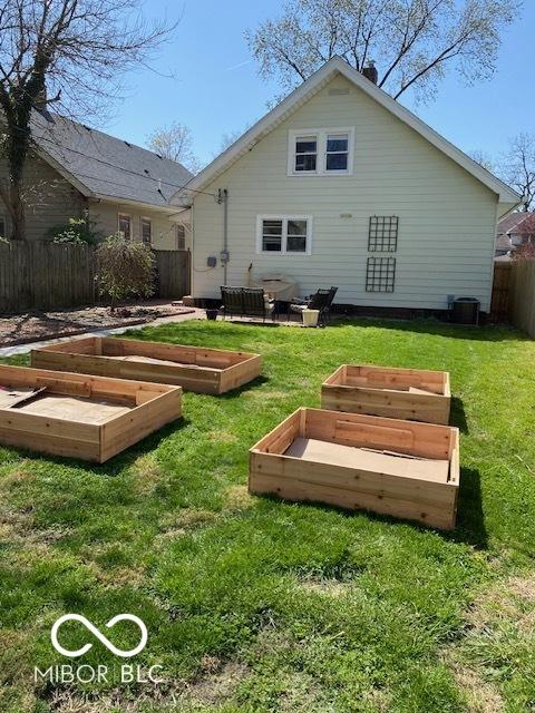 1311 N Oakland Ave, Indianapolis, IN 46201 - rear view of house with a vegetable garden and central AC unit