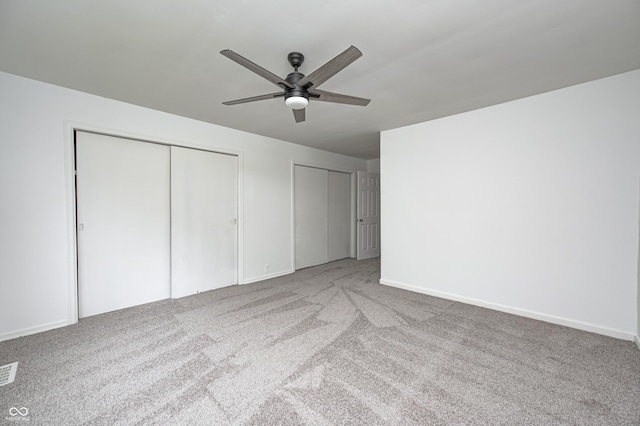 7414 Mendenhall Rd, Camby, IN 46113 - unfurnished bedroom with multiple closets, carpet, baseboards, and a ceiling fan