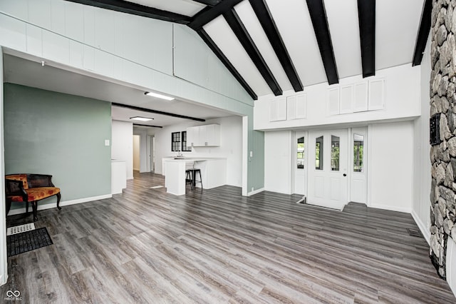 7414 Mendenhall Rd, Camby, IN 46113 - unfurnished living room with beam ceiling, high vaulted ceiling, wood finished floors, and baseboards