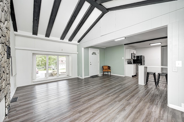 7414 Mendenhall Rd, Camby, IN 46113 - unfurnished living room featuring beamed ceiling, wood finished floors, high vaulted ceiling, and baseboards