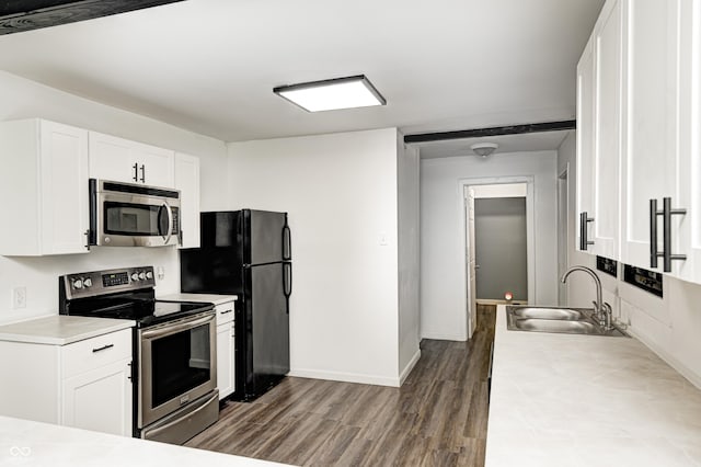 7414 Mendenhall Rd, Camby, IN 46113 - kitchen featuring stainless steel appliances, a sink, dark wood-type flooring, light countertops, and white cabinetry