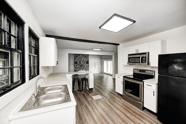7414 Mendenhall Rd, Camby, IN 46113 - kitchen with appliances with stainless steel finishes, a sink, white cabinetry, and light countertops