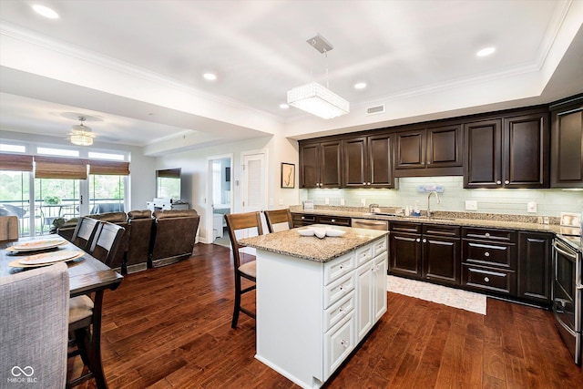 20971 Shoreline Ct Unit 201, Noblesville, IN 46062 - kitchen with open floor plan, a kitchen bar, light stone counters, dark brown cabinets, and ornamental molding