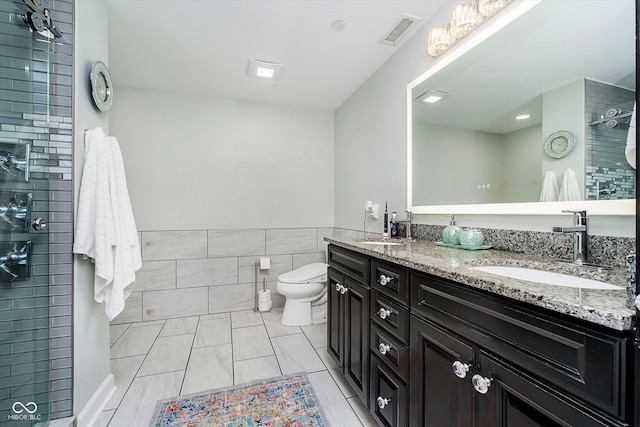 20971 Shoreline Ct Unit 201, Noblesville, IN 46062 - bathroom featuring tile walls, double vanity, a tile shower, a wainscoted wall, and tile patterned flooring