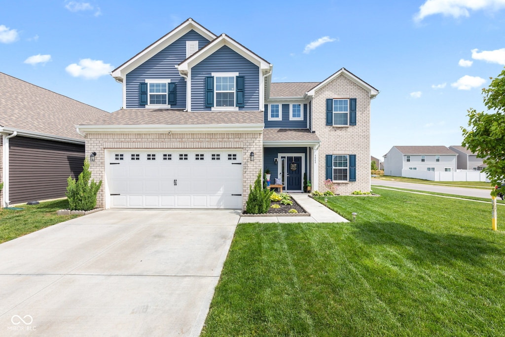 5848 Sheffield Ln, Whitestown, IN 46075 - traditional-style home with a front yard, concrete driveway, an attached garage, and brick siding