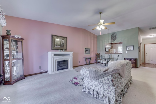 2025 Flamingo Way, Franklin, IN 46131 - living area with carpet, a ceiling fan, a glass covered fireplace, baseboards, and vaulted ceiling