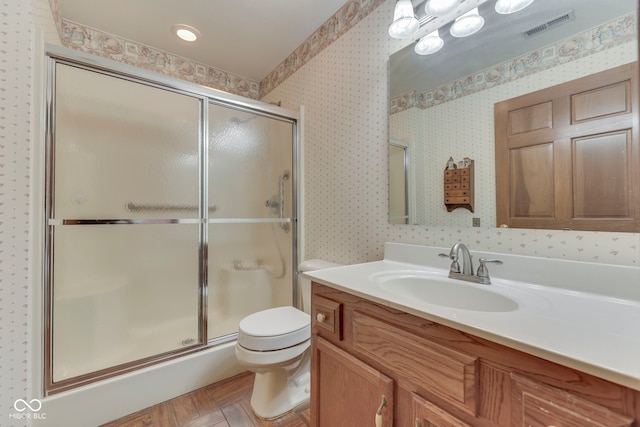 2025 Flamingo Way, Franklin, IN 46131 - bathroom with vanity, a shower stall, toilet, and wallpapered walls
