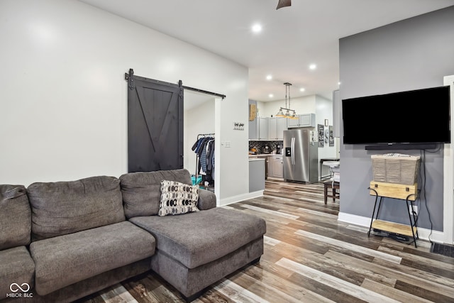 117 N Market St, Thorntown, IN 46071 - living room featuring a barn door, recessed lighting, light wood-style flooring, and baseboards