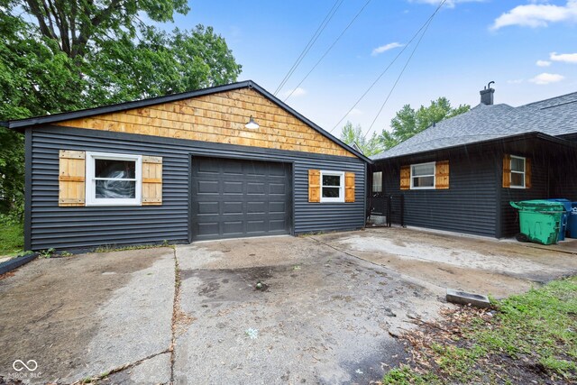 117 N Market St, Thorntown, IN 46071 - view of front of house with concrete driveway, a garage, and an outdoor structure